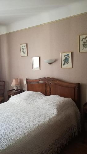 a bedroom with a bed with a white comforter at La Gineste in Serres