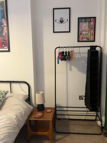 a bedroom with a bed and a table with a lamp at Ensuite Victorian double, excellent transport links to Bham in Birmingham