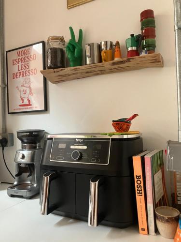 a kitchen with a black espresso machine on a counter at Ensuite Victorian double, excellent transport links to Bham in Birmingham