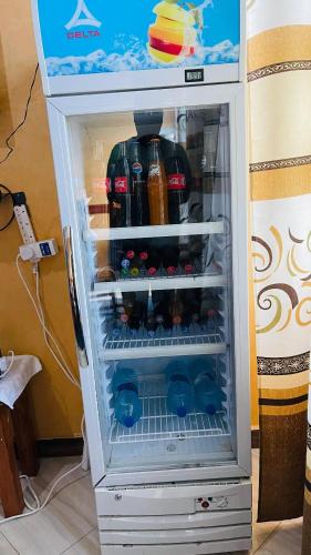 an open refrigerator filled with lots of drinks at R Kelly Tanzania in Arusha