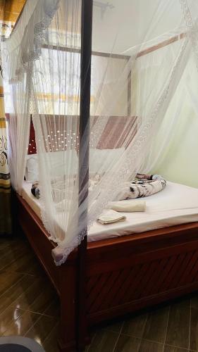a bed with mosquito netting on top of it at R Kelly Tanzania in Arusha