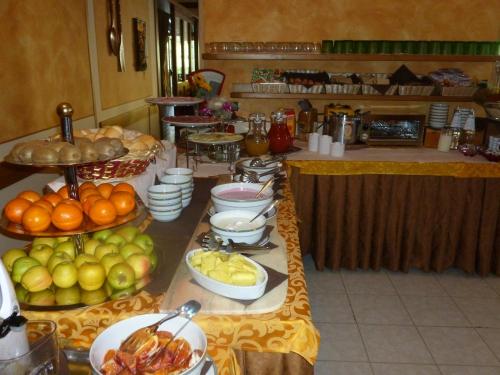 a buffet with fruits and vegetables on a table at Hotel Cima d'Oro in Ledro