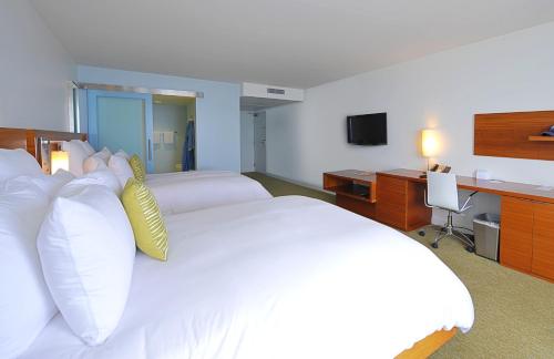 
a hotel room with a bed and a television at Tower 23 Hotel in San Diego
