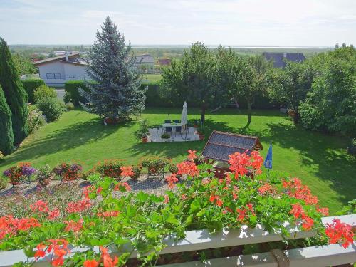 a view of a garden with flowers and a bench at Haus Margarethe in Mörbisch am See
