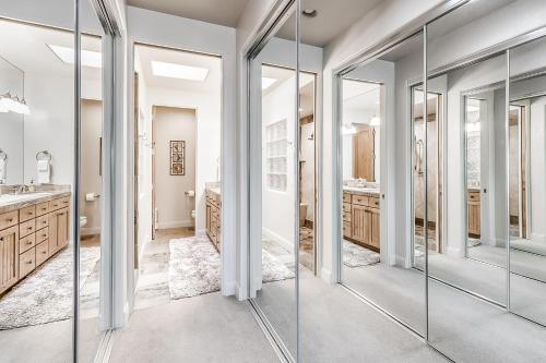 a bathroom with glass doors and a sink at Santa Clara Sunrise in Santa Clara