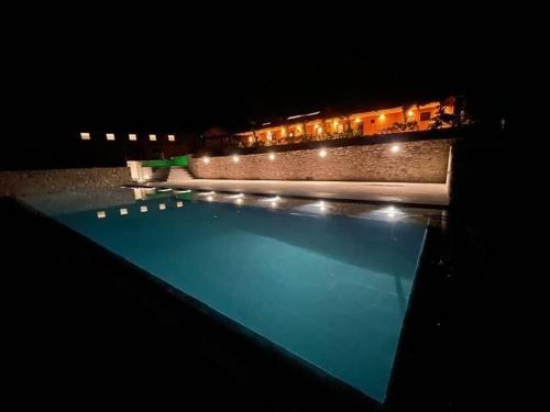 a view of a swimming pool at night at Agriturismo Casale Montebello in Monteleone di Spoleto