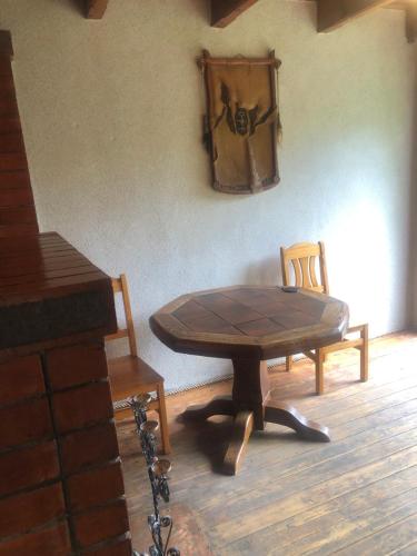 a table and a chair in a room at Sweet Honey homestay in Jūrmala