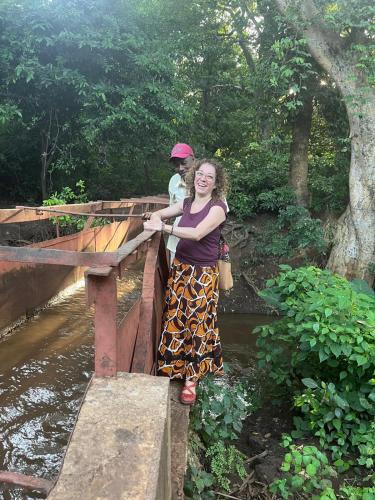 a woman standing on top of a bridge at Jangwani River View Suits in Mto wa Mbu