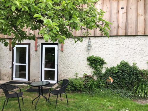 a table and chairs in front of a building at Sweet Honey homestay in Jūrmala