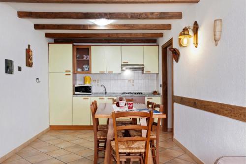 a kitchen with a table and chairs in a room at La Vieille Cloche in Saint-Rhémy-en-bosses