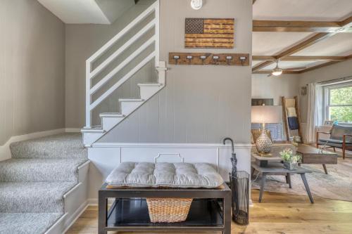 a living room with a staircase and a table at Outlaw Homestead in Deadwood