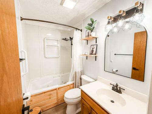 a bathroom with a sink and a toilet and a tub at Red Rock Ranch in Cosby