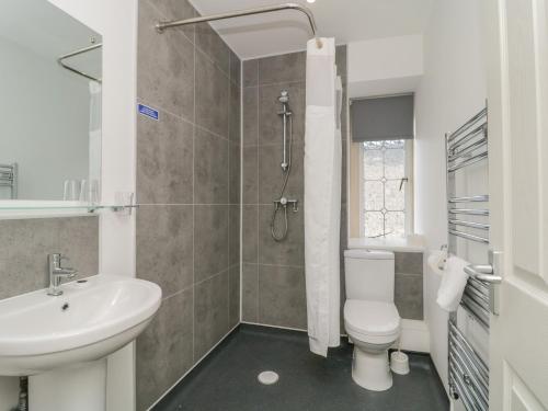 a white bathroom with a sink and a toilet at Harcombe Heights at Harcombe House in Newton Abbot