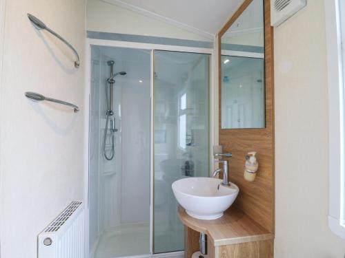 a bathroom with a sink and a shower at Bluebird in Clacton-on-Sea