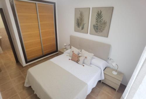 a bedroom with a white bed and a large window at Laurent's house - ATTC International Vacations in Isla del Fraile