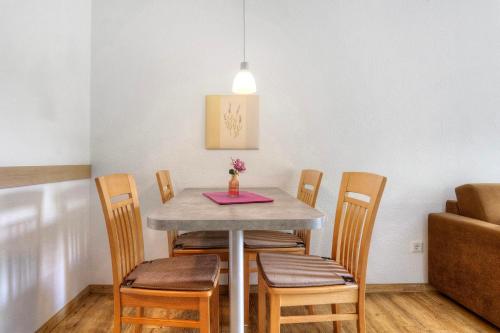 a dining room table with chairs and a pink napkin at Göckes Haus Und Garten Lavendelbeet in Wettringen