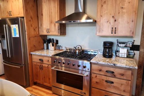 a kitchen with a stove and a refrigerator at Lakefront on Lake Shore in Joseph