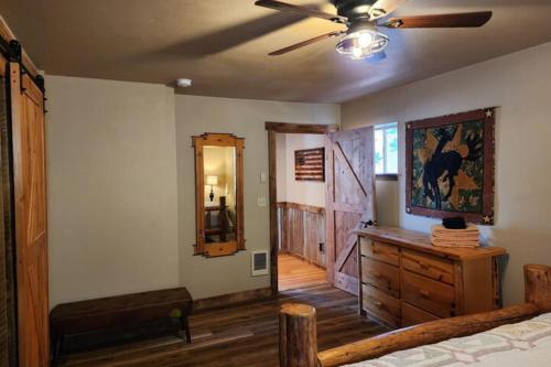 a bedroom with a bed and a dresser and a ceiling fan at Lakefront on Lake Shore in Joseph