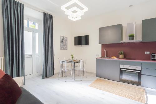 a living room with a kitchen and a dining room at Cernobbio Dream Suites by Rent All Como in Cernobbio