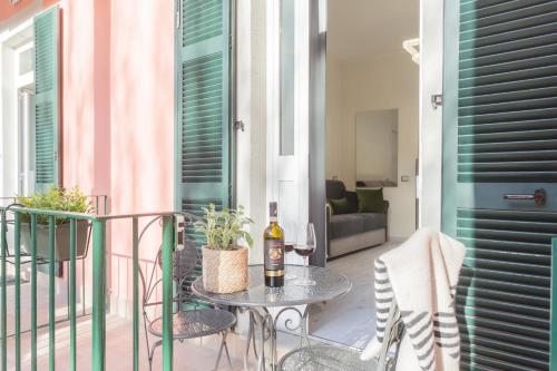 a table with a bottle of wine on a balcony at Cernobbio Dream Suites by Rent All Como in Cernobbio