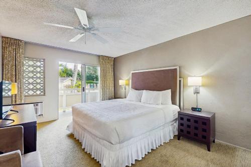 a bedroom with a bed and a ceiling fan at Plantation Hale #C5 in Kapaa