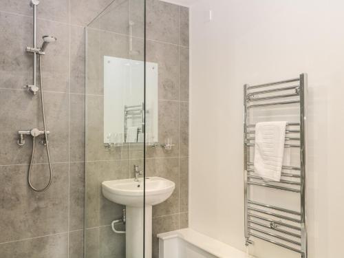 a bathroom with a sink and a shower at Harcombe House Rooms - First Floor King in Newton Abbot