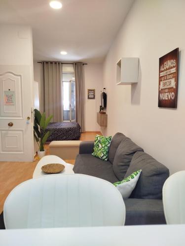 a living room with a couch and a table at NICE HOME city center in Melilla