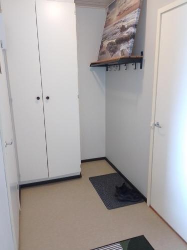 a room with white cabinets and a rug at Flexible Myllykallio in Jyväskylä