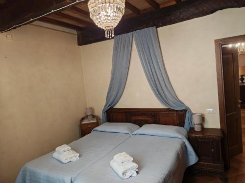 a bedroom with two beds with towels on them at Villa Torricelli Scarperia - Il Giardinetto Residence in Scarperia