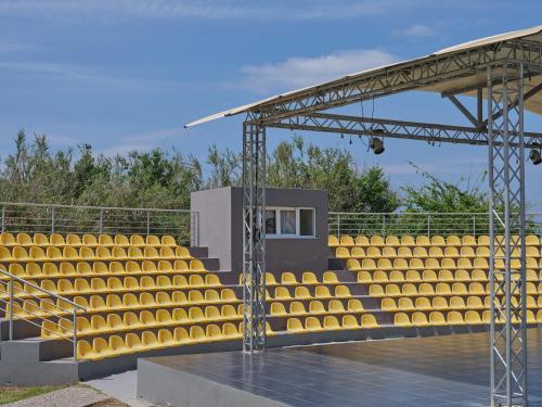 a group of yellow seats in a stadium at Atlantica Thalassa Hotel in Kos Town