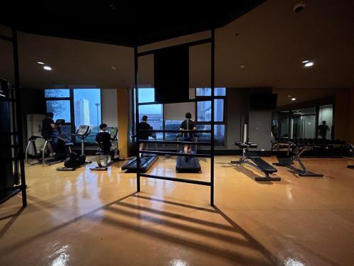 a gym with people exercising on machines in a building at Bayview near CCP, PICC, Airport, MOA, Okada at Radiance in Manila