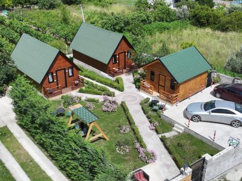 a model of a house with a car parked in a parking lot at Wood House Berat in Berat