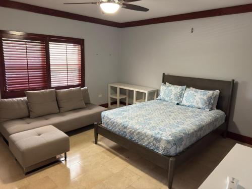a bedroom with a bed and a couch at Hits the Spotts in Savannah