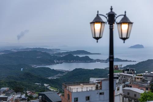 a street light with a view of the water at Jiufen Nostalgic Inn in Jiufen