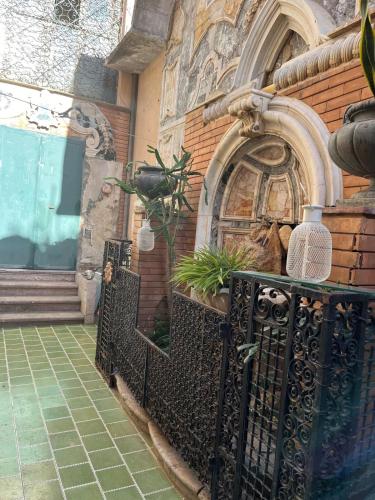 a building with a gate and a brick wall at A CASA DEL CONSOLE in Mondello