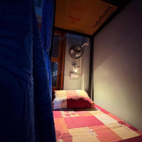a bedroom with a bed and a window in a room at Sangita Homestay in Siliguri
