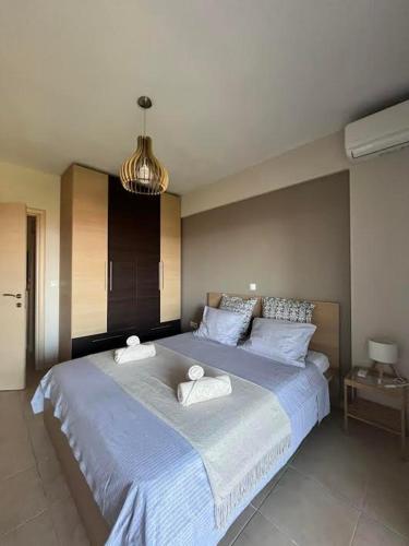 a bedroom with a large bed with two towels on it at Stone House in Afytos in Afitos
