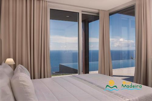 a bedroom with a view of the ocean at OurMadeira - Cliffscape, panoramic seaviews in Estreito da Calheta