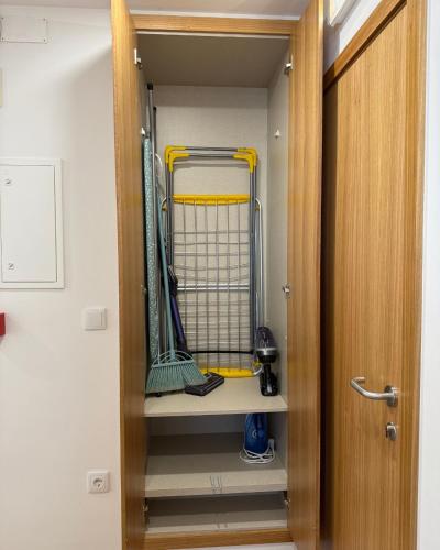 a walk in closet with hockey equipment in it at Guest House MJ in Póvoa de Varzim