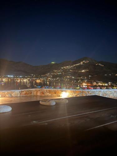 a view of a city at night with a mountain at Amfitriti Serifos in Livadion