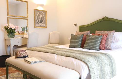 a bedroom with a large bed with pillows on it at Château de Berne in Lorgues
