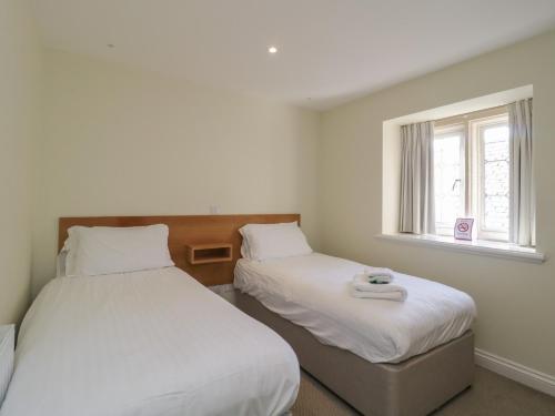 a bedroom with two beds and a window at The Devon Drift at Harcombe House in Newton Abbot