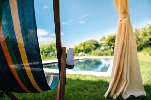 two lawn chairs sitting next to a swimming pool at Villa Pellegrini in Grezzana