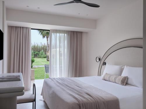 A bed or beds in a room at Atlantica Thalassa Hotel
