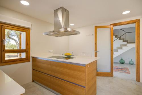 a kitchen with a island with a counter top at Can Cadernera by Rentallorca in Can Picafort