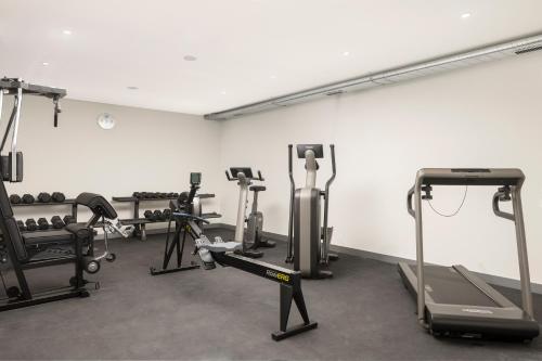 a gym with several treadmills and exercise bikes at Holiday Inn Express & Suites Sion by IHG in Sion