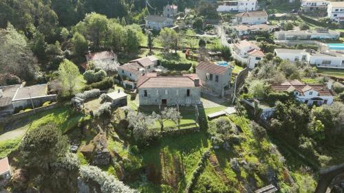 an aerial view of a house on a mountain at A Quinta Lanhelas River View in Caminha