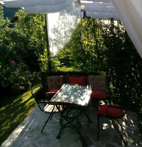 a table and two chairs on a patio at Diamat in Ivišovo Greblje