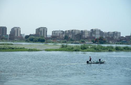 two people are on a boat in the water at Nile Transportation hotel in Cairo