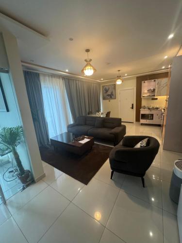 a large living room with two couches and a table at Abram Hills Hotel Ltd in Koforidua